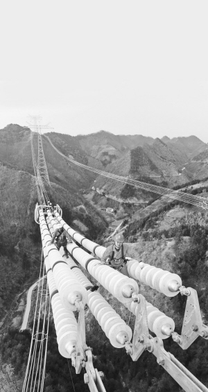 銀色巨龍越秦嶺――昌吉―古泉特高壓陜3標段建設(shè)現(xiàn)場走筆　　施工人員在導(dǎo)線上作業(yè)。 　　開欄的話：從千里沃野到莽莽群山，從東海之濱到天山腳下，一基基鐵塔拔地而起，一條條銀線伸向遠方，電能為決勝全面建成小康社會注入強勁的動力
